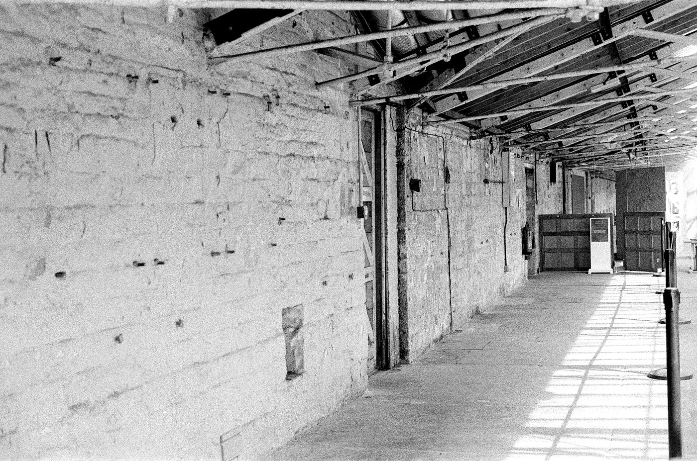 Lange, leere Halle mit Betonboden, schwarzweiß